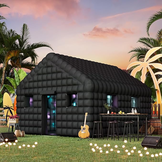 Black inflatable nightclub tent set up outdoors with a pool in the background. The structure has large windows on the side, tables and chairs arranged outside, and features a colorful logo above the entrance.